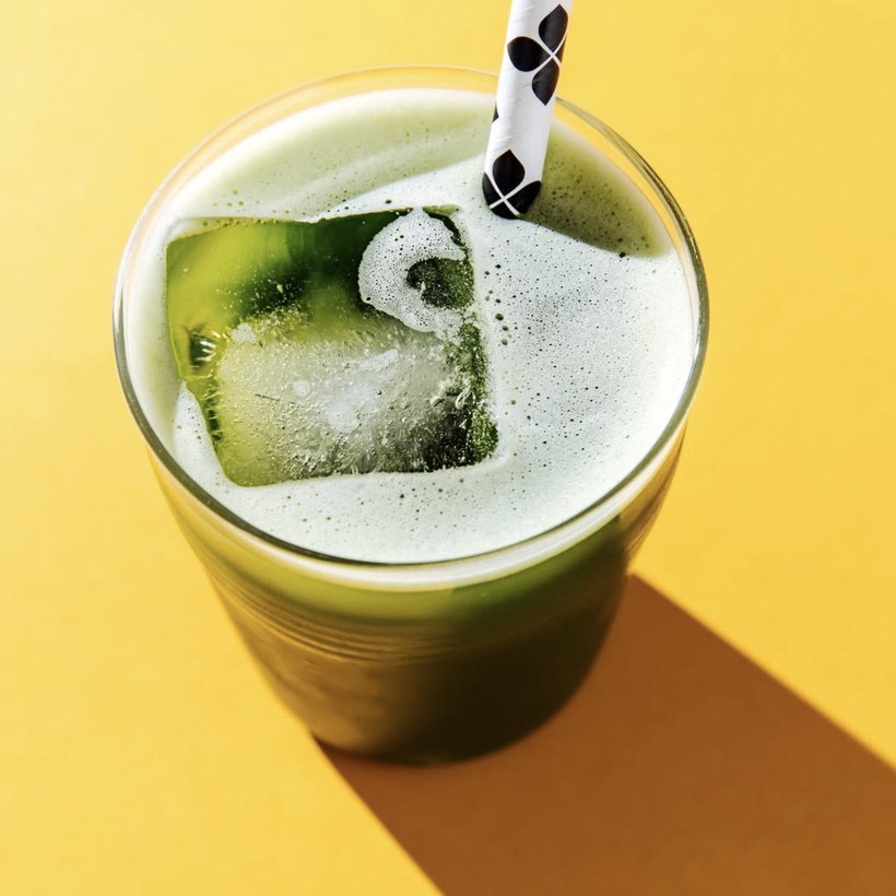 Iced matcha with a striped straw