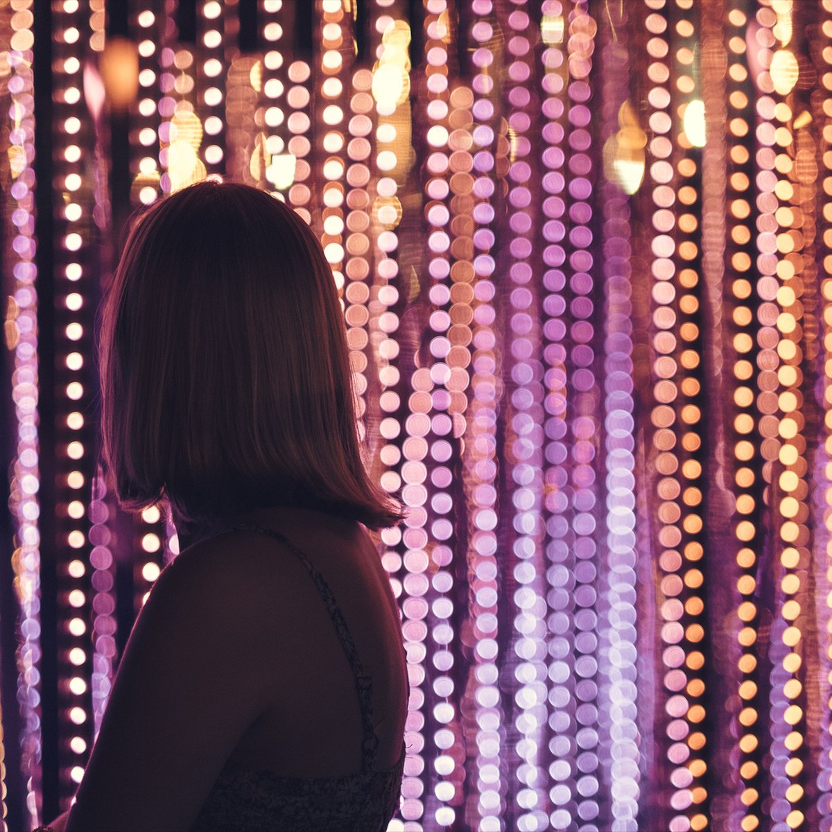 A visitor silhouetted against the glowing sculpture